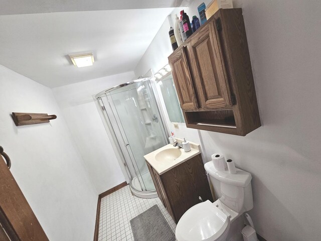 bathroom with a stall shower, toilet, tile patterned flooring, and vanity