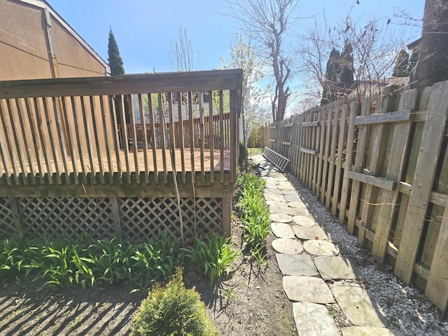 wooden deck with a fenced backyard