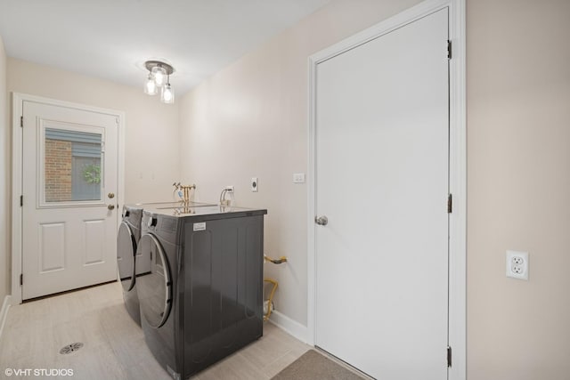laundry area featuring laundry area, washer and clothes dryer, and baseboards