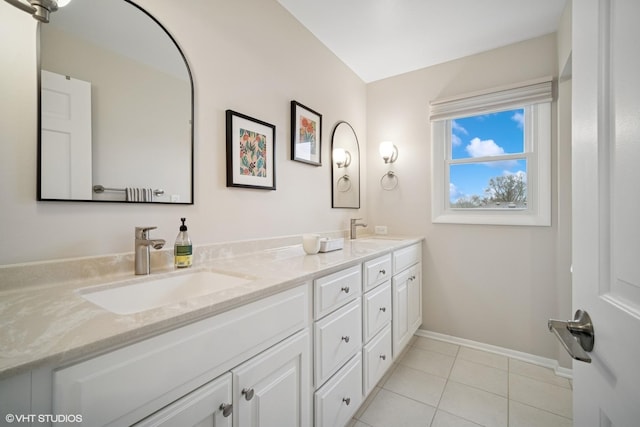 full bath featuring a sink, baseboards, tile patterned flooring, and double vanity
