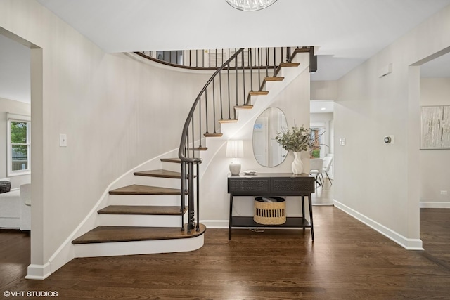 stairway with baseboards and wood finished floors