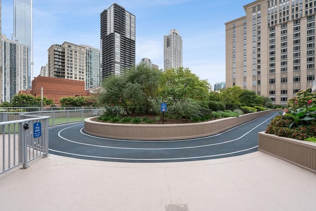 view of community featuring fence and a city view