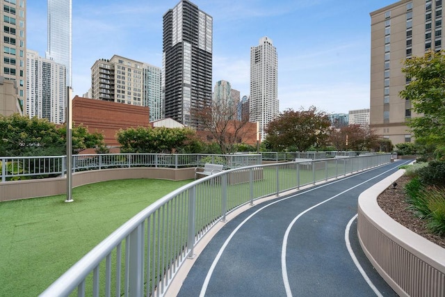 surrounding community featuring fence and a city view