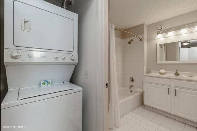 bathroom featuring stacked washer and dryer, a textured ceiling, shower / tub combo, tile patterned floors, and vanity