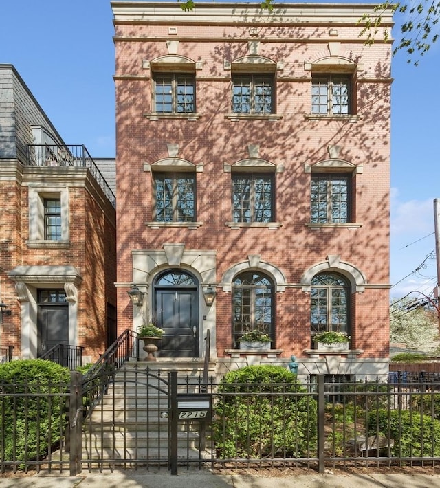 2215 N Lakewood Ave, Chicago, IL 60614 - view of front of house featuring a fenced front yard, a gate, and brick siding