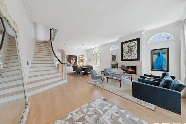 2215 N Lakewood Ave, Chicago, IL 60614 - living room with stairway, a fireplace, a notable chandelier, crown molding, and wood finished floors