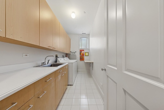 2215 N Lakewood Ave, Chicago, IL 60614 - laundry room with light tile patterned floors, cabinet space, washing machine and clothes dryer, a sink, and baseboards