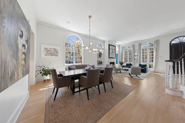 2215 N Lakewood Ave, Chicago, IL 60614 - dining area with ornamental molding, light wood-style flooring, and a healthy amount of sunlight