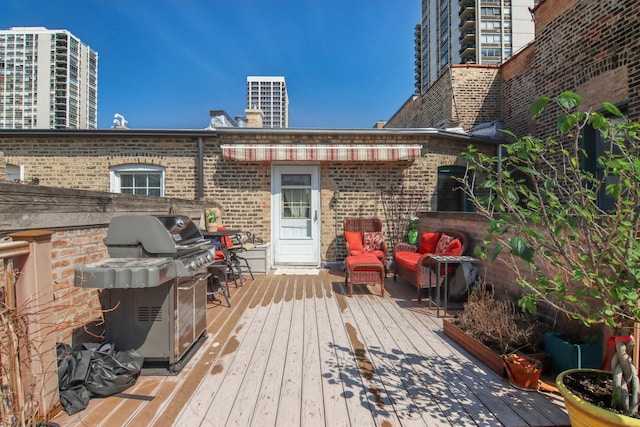 1400 N La Salle St Unit 3N, Chicago, IL 60610 - wooden deck with area for grilling and outdoor lounge area