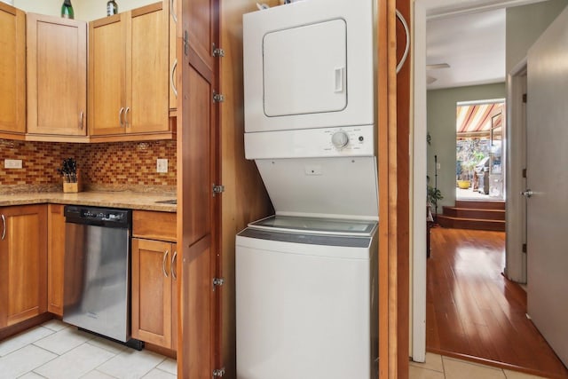 1400 N La Salle St Unit 3N, Chicago, IL 60610 - washroom featuring stacked washing machine and dryer and light tile patterned floors