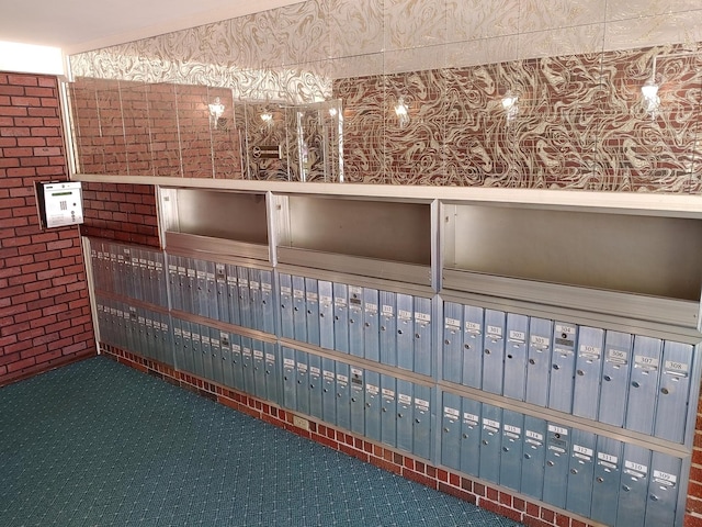 interior details with wallpapered walls, carpet floors, and mail area