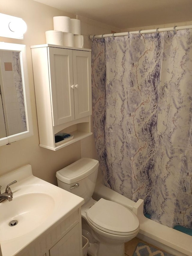 bathroom featuring toilet and vanity
