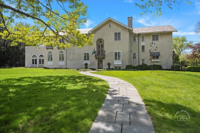 back of property featuring a yard and a chimney