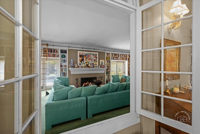 living area featuring a lit fireplace
