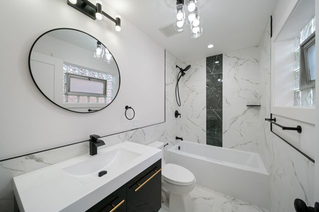 519 E 91st St, Chicago, IL 60619 - full bathroom featuring tub / shower combination, marble finish floor, toilet, and vanity