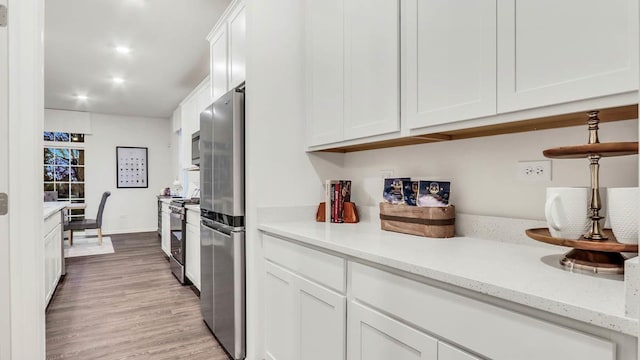 260 Snowdrop Ln, Elgin, IL 60124 - kitchen with light wood-type flooring, recessed lighting, white cabinetry, light stone counters, and appliances with stainless steel finishes