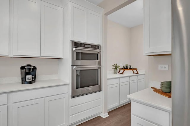 260 Snowdrop Ln, Elgin, IL 60124 - kitchen featuring wood finished floors, stainless steel appliances, light countertops, and white cabinetry