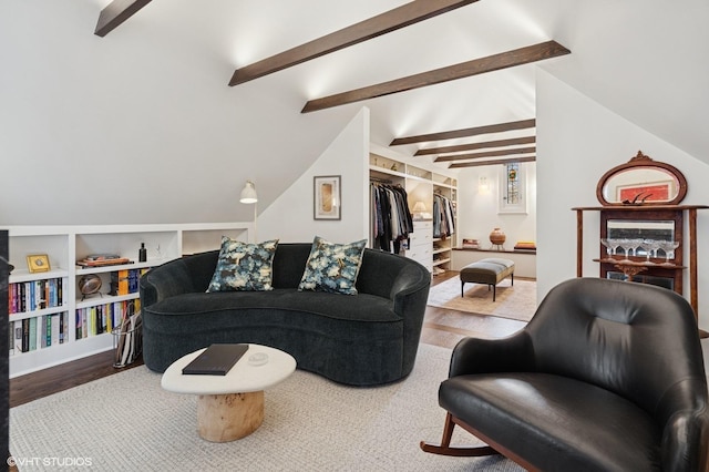 living area featuring wood finished floors and lofted ceiling with beams