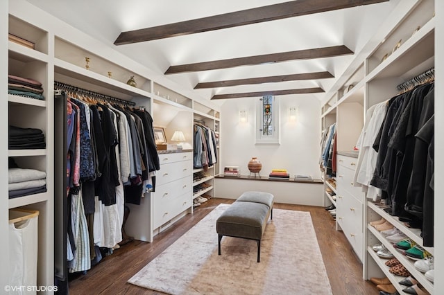 spacious closet with beam ceiling and dark wood finished floors