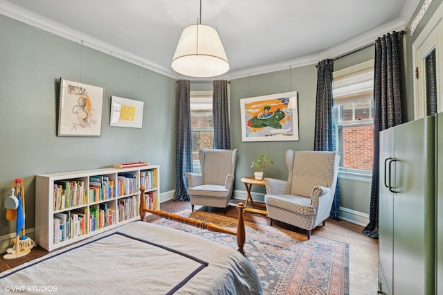 bedroom with crown molding, multiple windows, wood finished floors, and baseboards