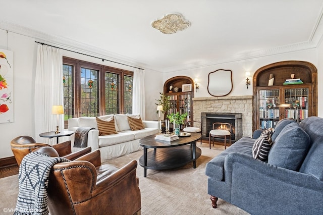 living area featuring ornamental molding and a fireplace