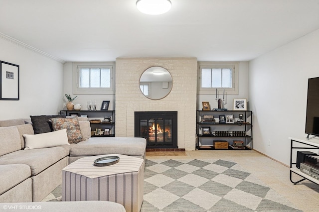 carpeted living area with ornamental molding and a brick fireplace