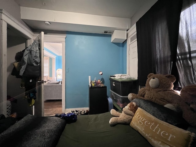 bedroom with wood finished floors and visible vents