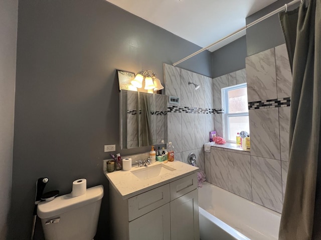 bathroom featuring bathing tub / shower combination, vanity, toilet, and tile walls