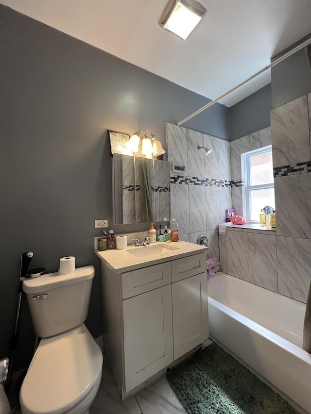 bathroom featuring vanity, lofted ceiling, toilet, and shower / washtub combination