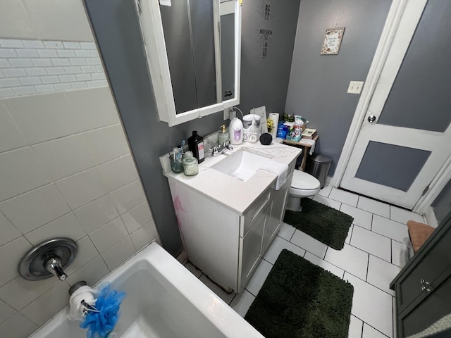 bathroom with toilet, tile patterned floors, and vanity