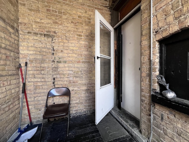 property entrance featuring brick siding