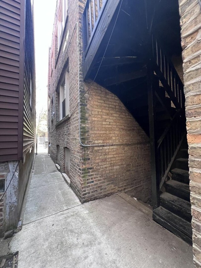 view of side of property featuring brick siding