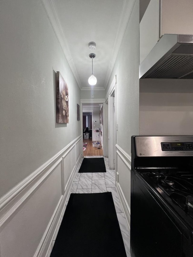 hall with ornamental molding, wainscoting, and marble finish floor