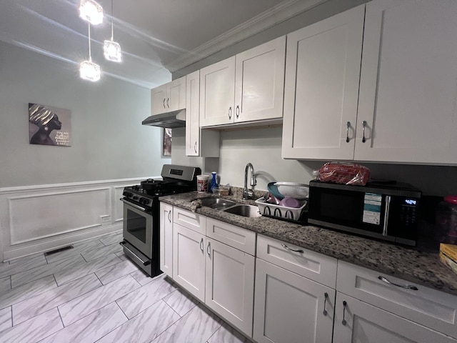 kitchen with under cabinet range hood, a sink, marble finish floor, ornamental molding, and stainless steel appliances