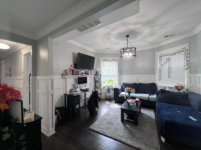 living room featuring ornamental molding, a decorative wall, dark wood-style flooring, and visible vents