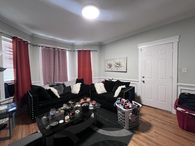 living area featuring ornamental molding and wood finished floors