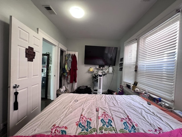 bedroom with visible vents and a closet