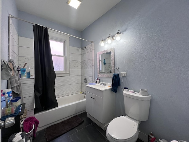 full bath featuring vanity, a textured wall, toilet, tile patterned floors, and shower / bath combo