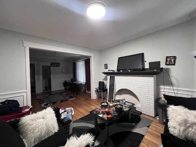 living area featuring light wood-type flooring and wainscoting