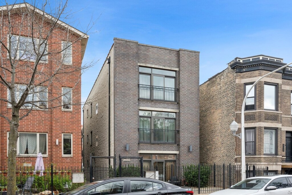 2309 W 21st St Unit 2, Chicago, IL 60608 - exterior space with brick siding and fence