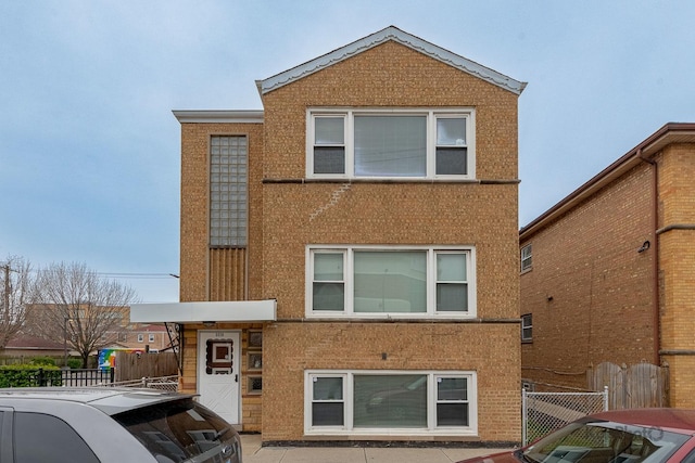 view of front of property featuring stucco siding and fence