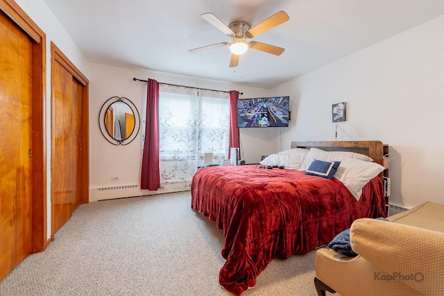 bedroom featuring a baseboard radiator, carpet, and a ceiling fan