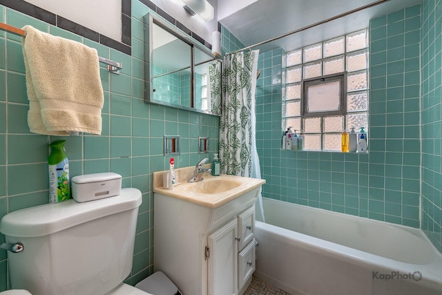 full bath featuring tile walls, vanity, toilet, and shower / tub combo with curtain