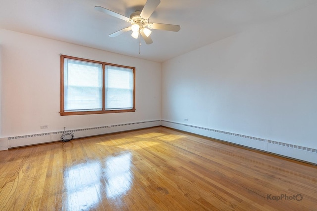 unfurnished room with a ceiling fan, baseboards, wood finished floors, a baseboard radiator, and a baseboard heating unit
