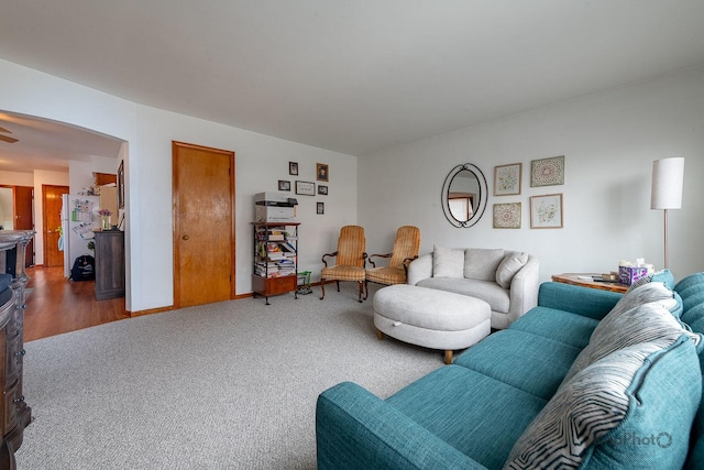 living room featuring carpet flooring and arched walkways