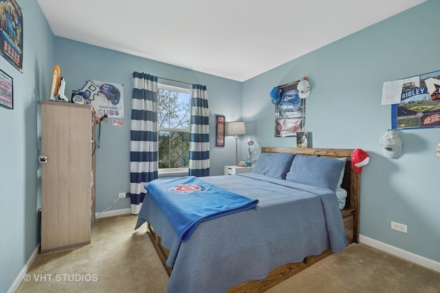 bedroom with baseboards and carpet