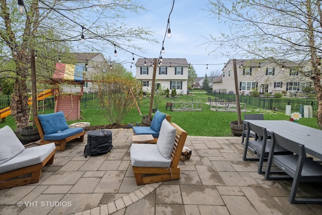 view of patio featuring a fenced backyard, a residential view, a playground, and an outdoor hangout area