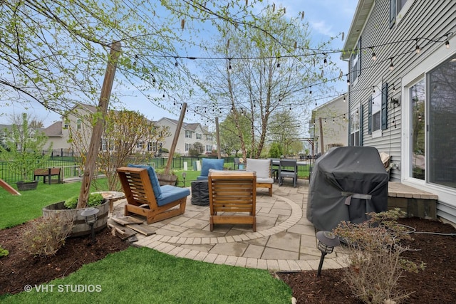 view of patio / terrace with area for grilling, an outdoor living space, a residential view, and a fenced backyard