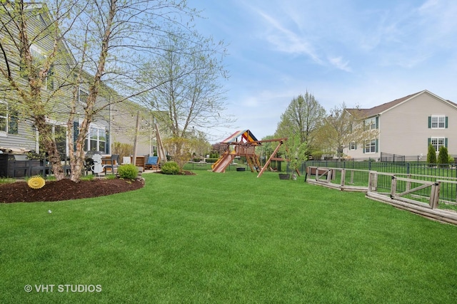 view of yard featuring fence and a playground