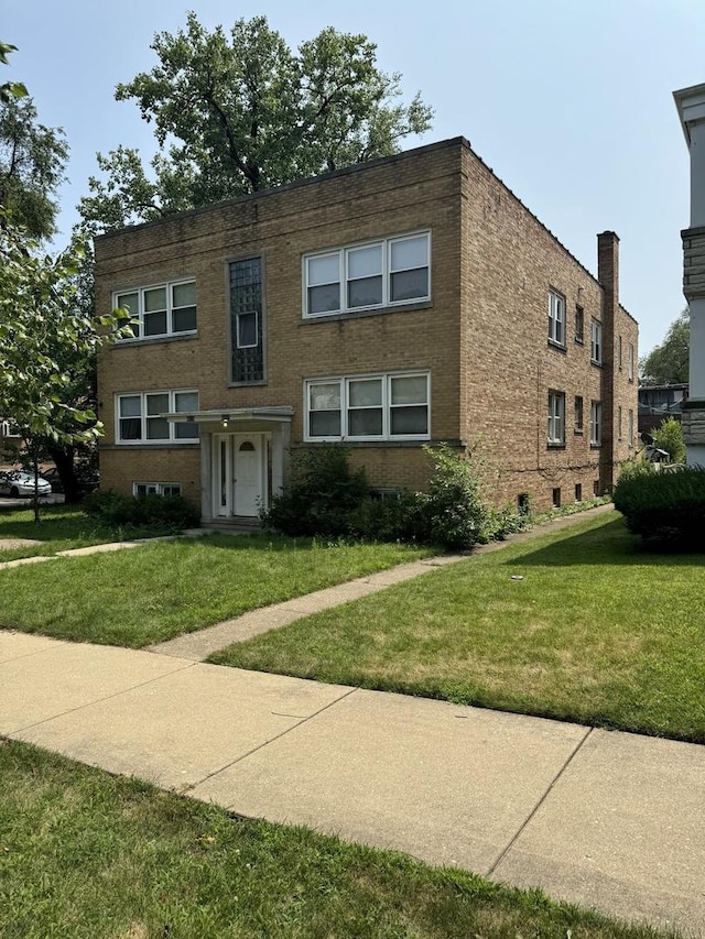 4819 Conrad St, Skokie, IL 60077 - view of front of home featuring brick siding and a front lawn